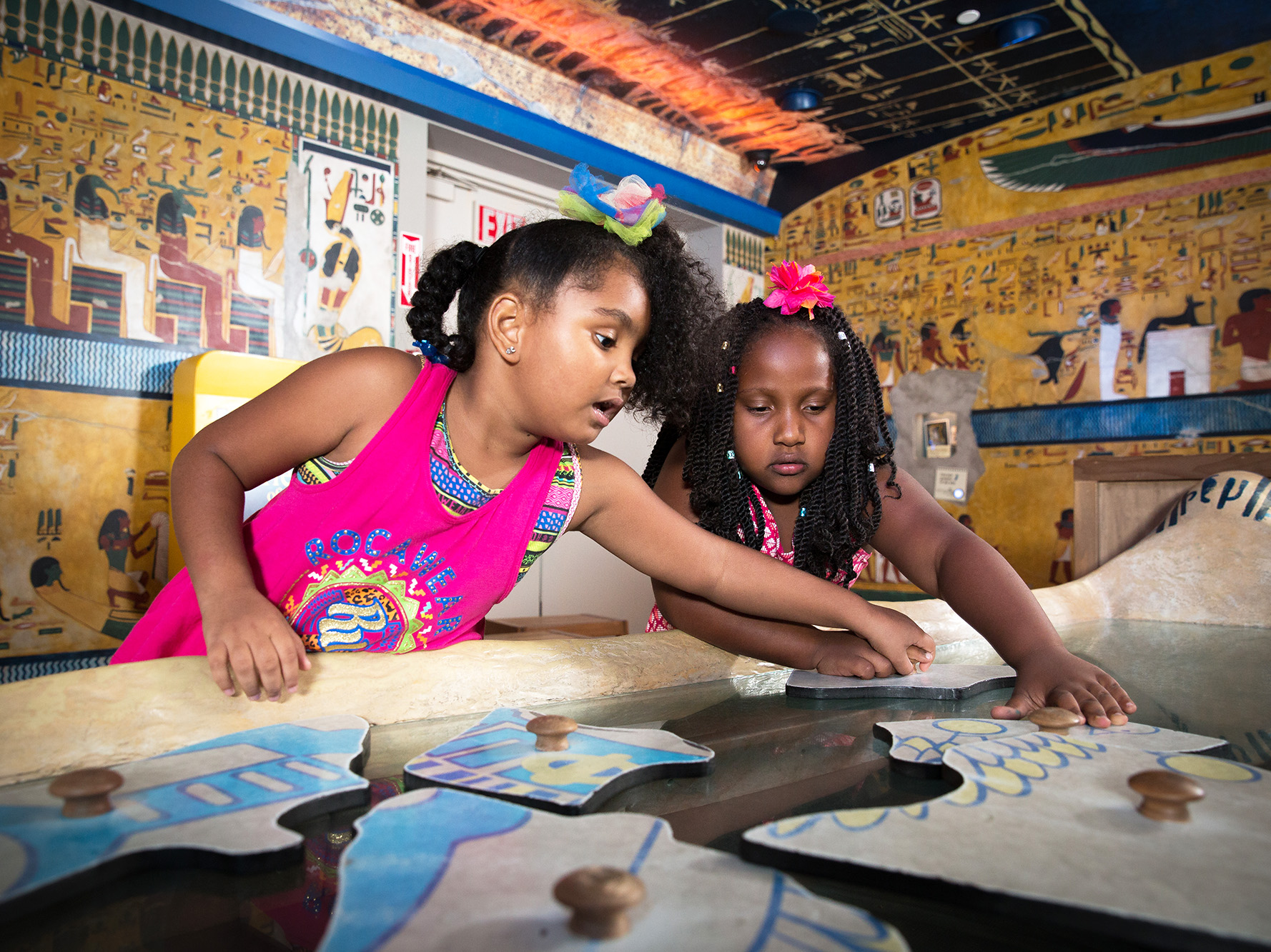 Children piecing together a puzzle.