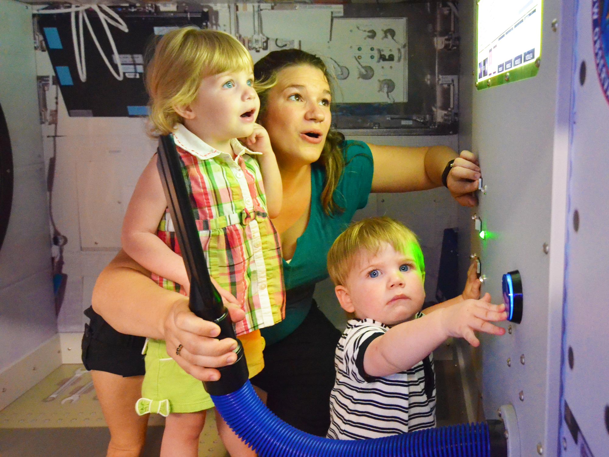 Grown-up and two children in Beyond Spaceship Earth exhibit.