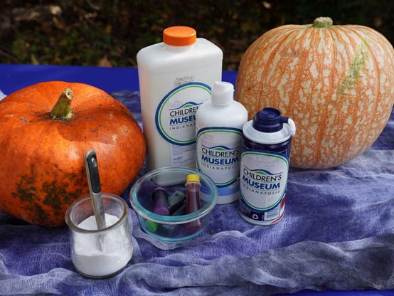 Two pumpkins next to Halloween slime ingredients.