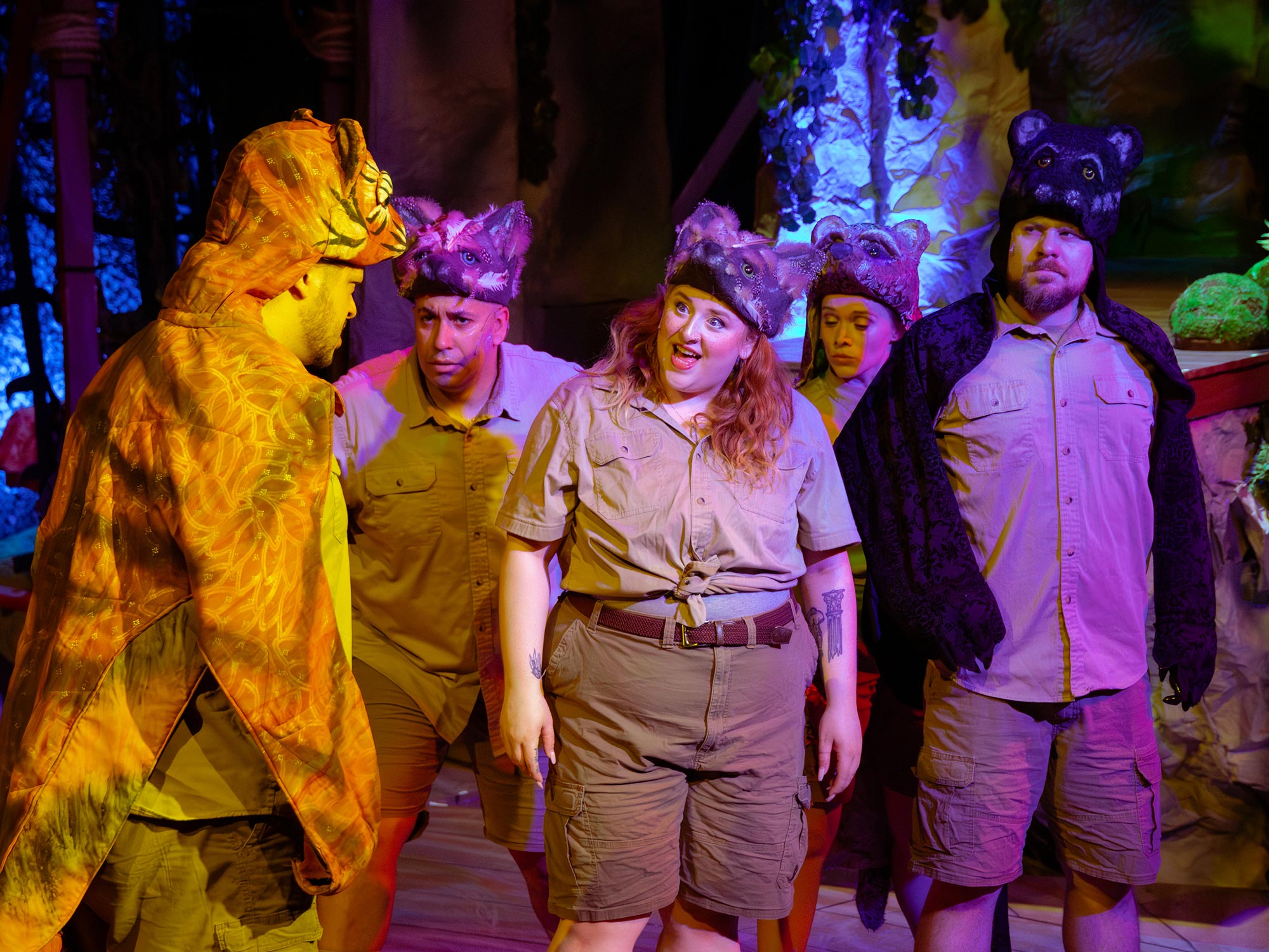 Actors wearing animal costumes on stage.