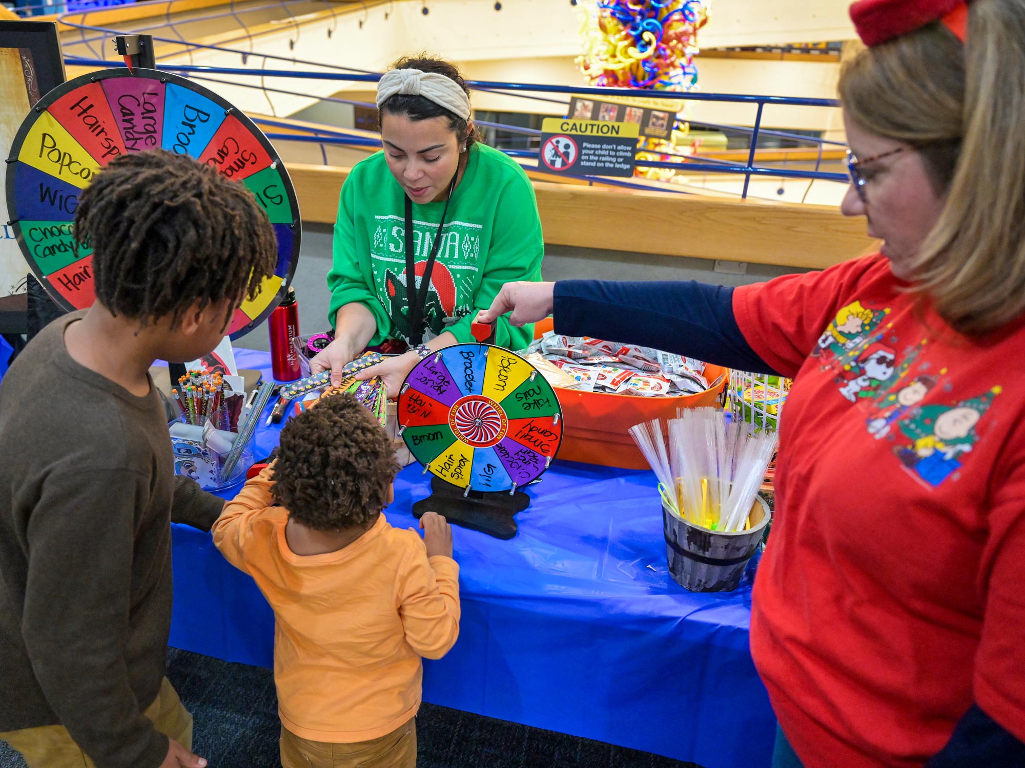 People playing a game with a prize wheel.