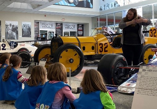 Children learning about a racecar at Access Pass cultural attraction Indianapolis Motor Speedway Museum