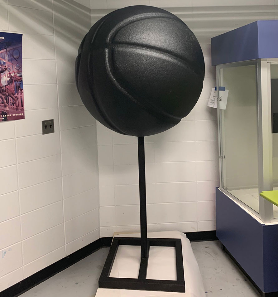 Behind the scenes photo of March Madness dinos basketball with LINE-X coating