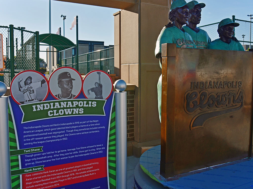 Sports Legends Hank Aaron, Peanut Johnson, and Toni Stone of the Indianapolis Clowns in front of Wiese Field on the Old National Bank Avenue of Champions in the Riley Children's Health Sports Legends Experience at The Children's Museum of Indianapolis