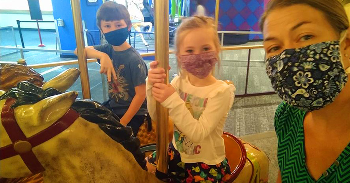 Wearing masks on the Carousel at The Children's Museum of Indianapolis