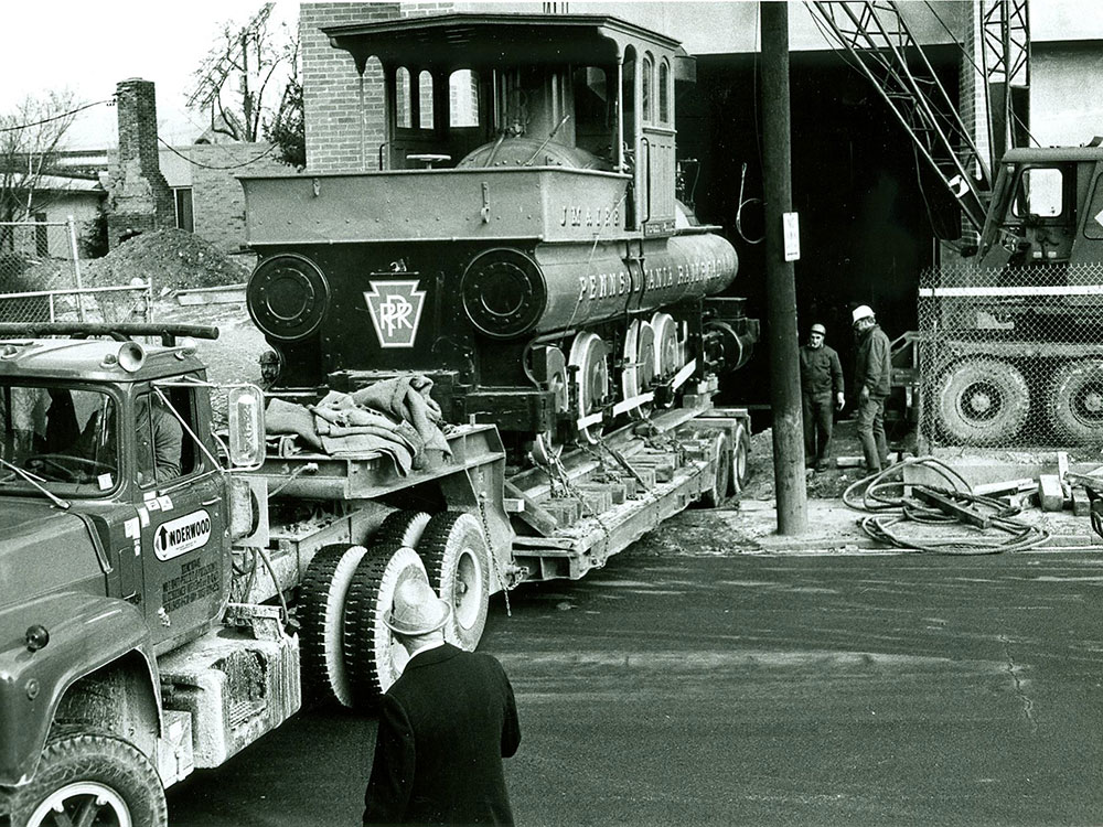 Historical photo of the Reuben Wells being loaded into the train shed.