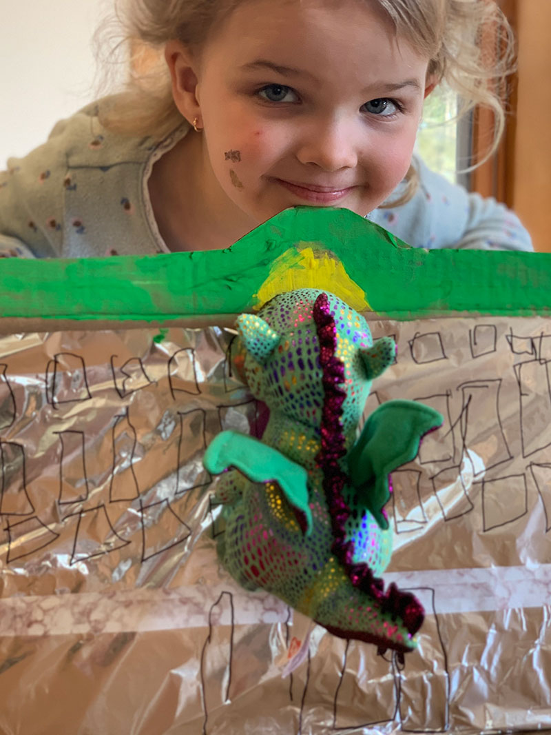 Preschool student posing with her model of The Children's Museum of Indianapolis