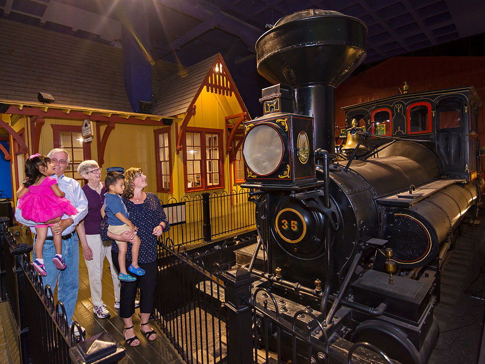 Family visiting the Reuben Wells in the All Aboard! exhibit at The Children's Museum of Indianapolis