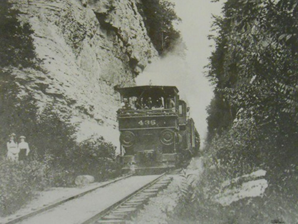 Historical photo of the Reuben Wells pushing a train up Madison Hill in Madison, IN