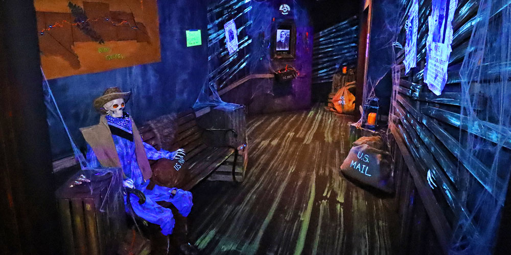 Cowboy skeleton and mailbags inside Bony Express room in the Frightful Frontier Haunted House at The Children's Museum of Indianapolis.