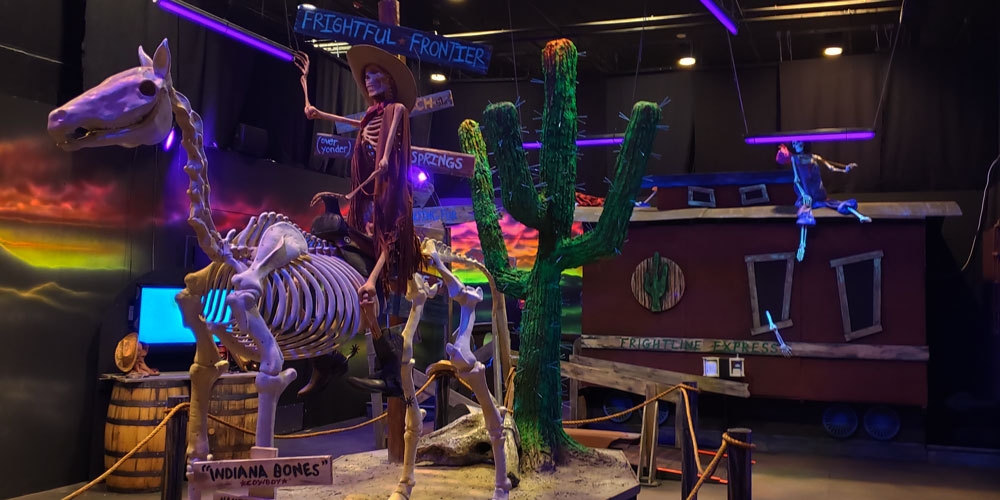 Cowboy skeleton and horse skeleton at the entrance to the Frightful Frontier Haunted House entrance at The Children's Museum of Indianapolis.