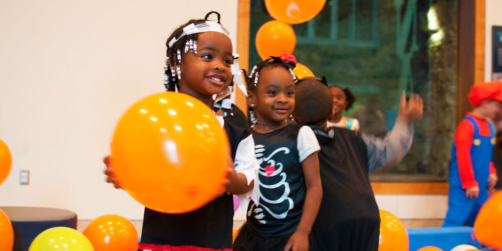 Children playing with big balloons at the Indiana State Museum's Family Fright Night