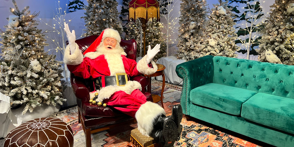 Santa reclining in a chair while waiting for families to visit inside Jolly Days Winter Wonderland.