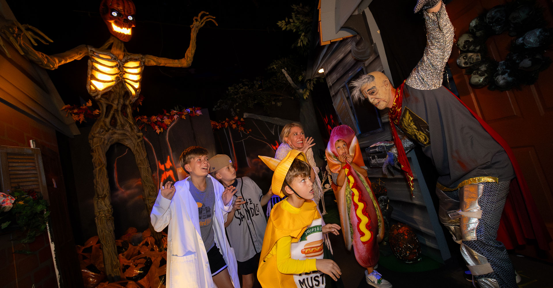 Children wearing costumes walking through the Haunted House.