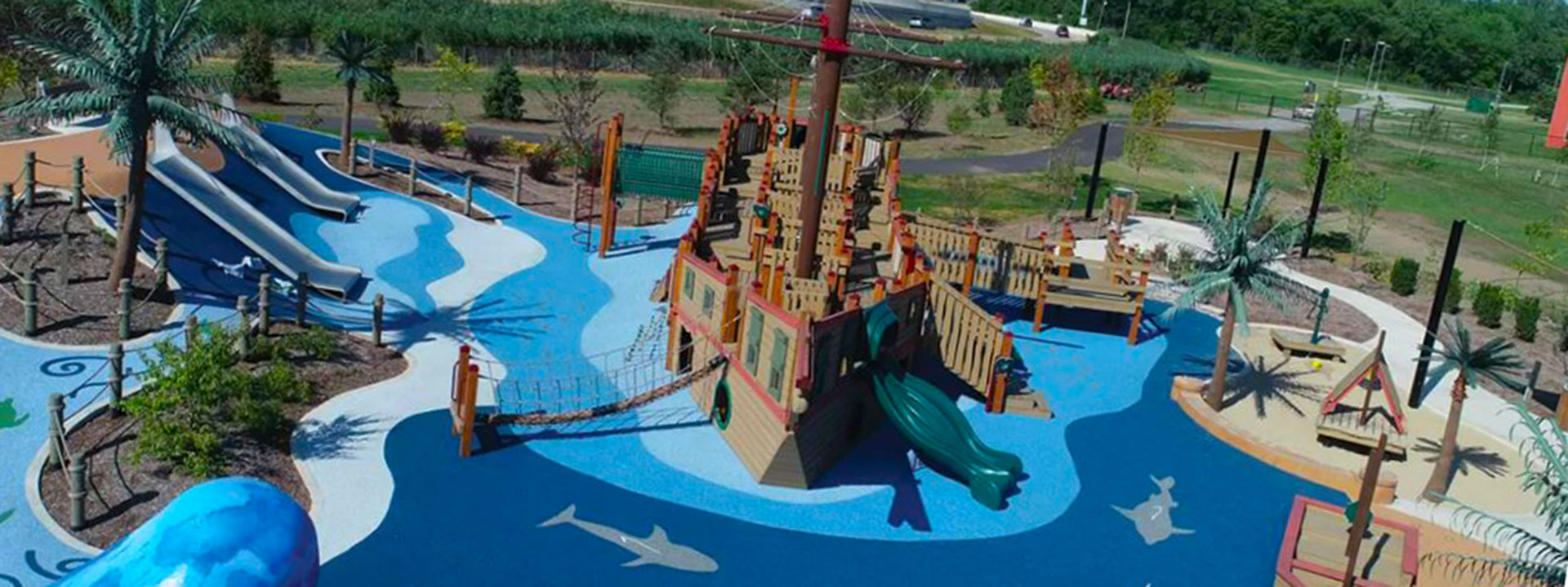 Access Pass cultural attraction Bellaboo's Imagination Garden play area with a pirate ship surrounded by blue landscaping that looks like water.