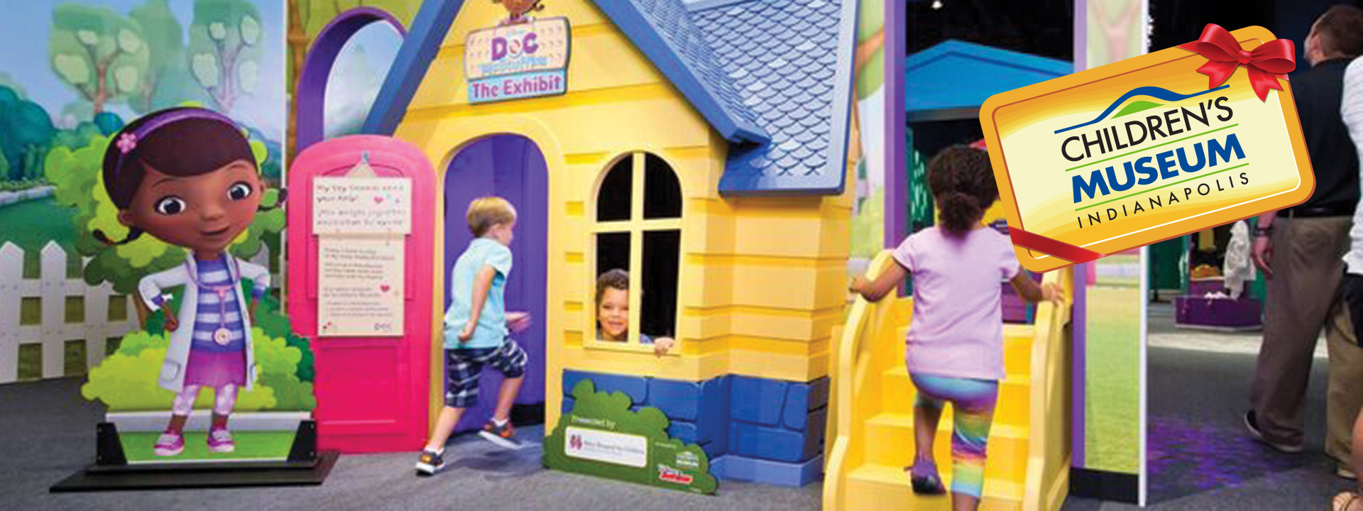 Doc McStuffins exhibit image featuring the McStuffins toy hospital with children