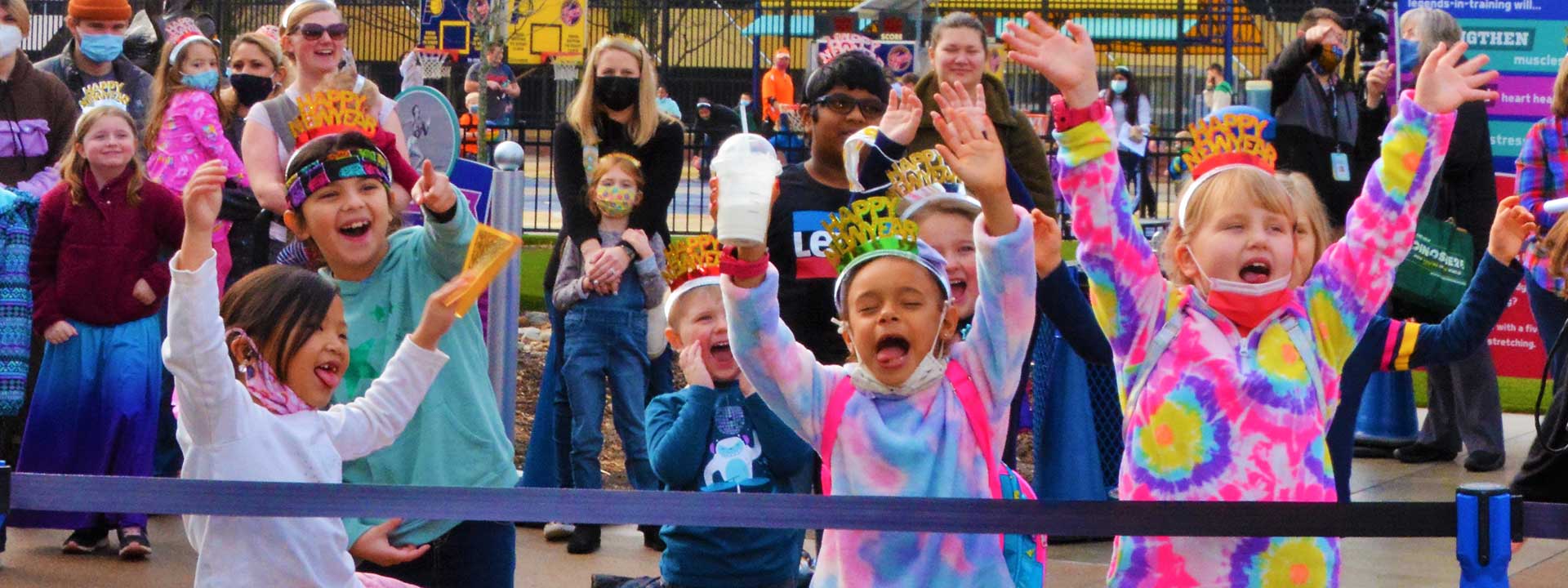 Children dancing and celebrating outside during Countdown to Noon in the Riley Children's Health Sports Legends Experience at The Children's Museum of Indianapolis
