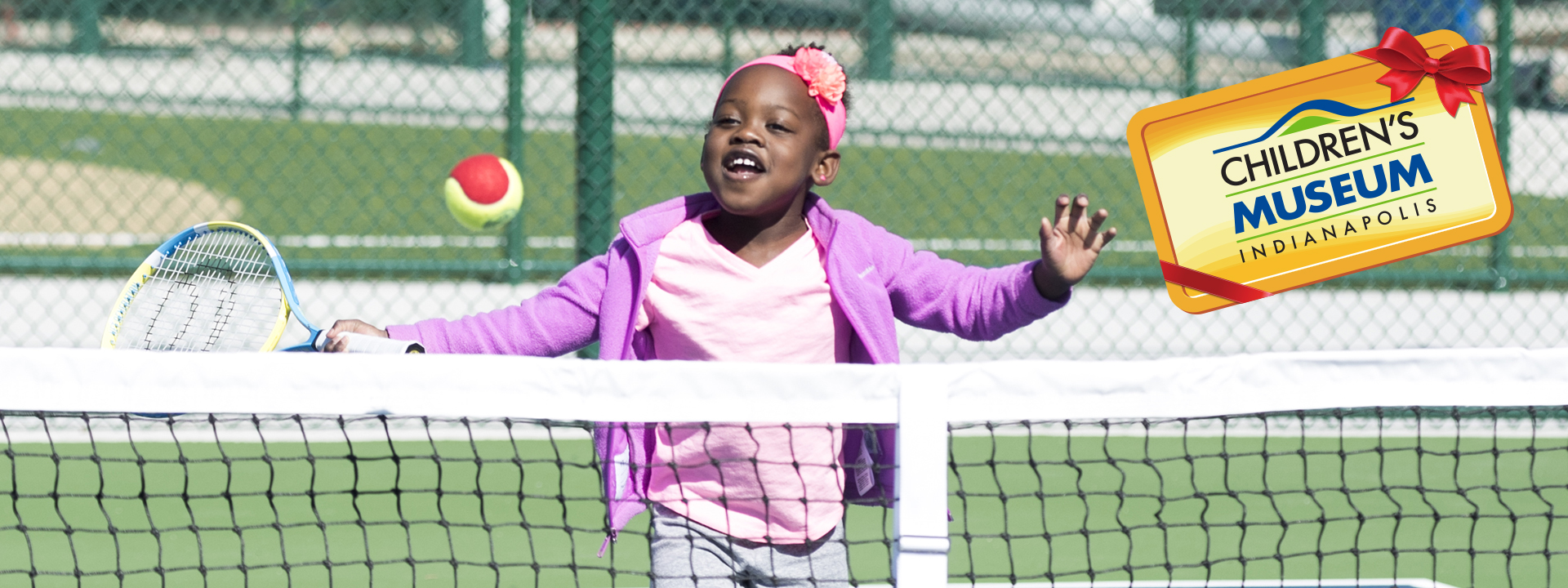 Young girl playing tennis in the Sports Experience