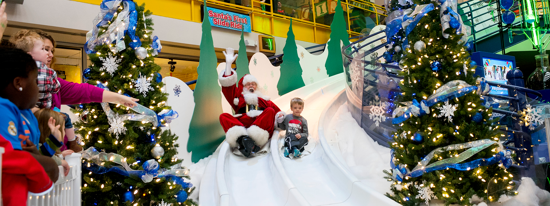 Santa and child going down the Yule Slide