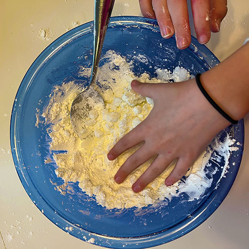 Mixing snowbleck materials in a blue bowl.