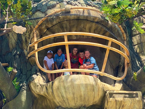 Family looking out from a platform in the Tree of Sports. It looks like they're inside a giant football helmet.