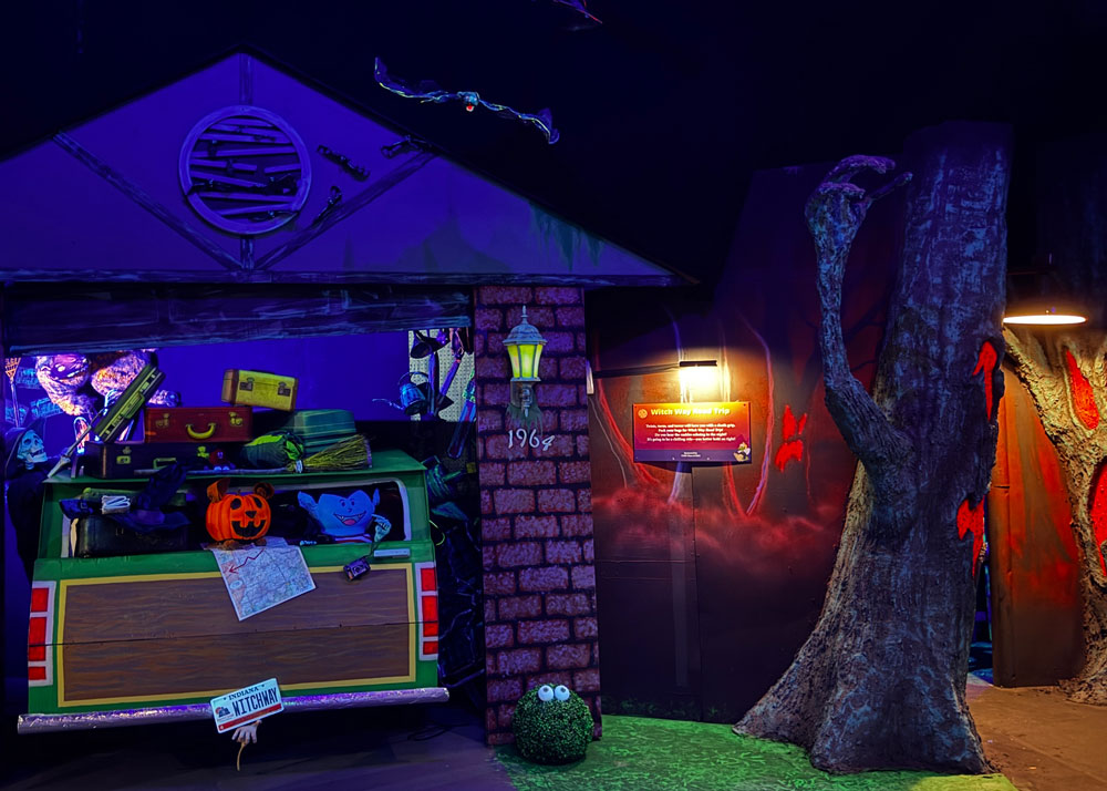 A loaded station wagon in its garage next to a haunted tree.